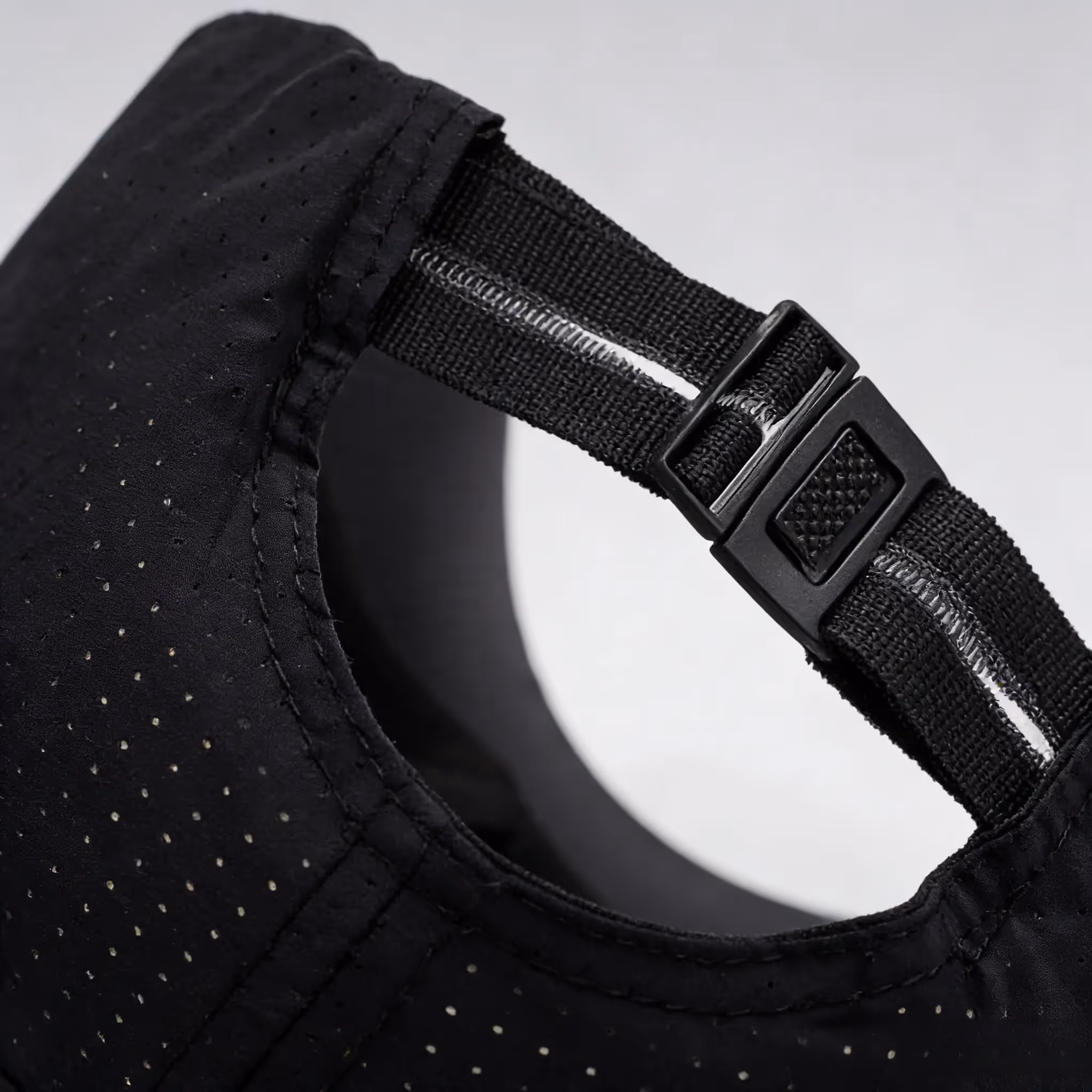 Close-up of adjustable rear strap on black cap